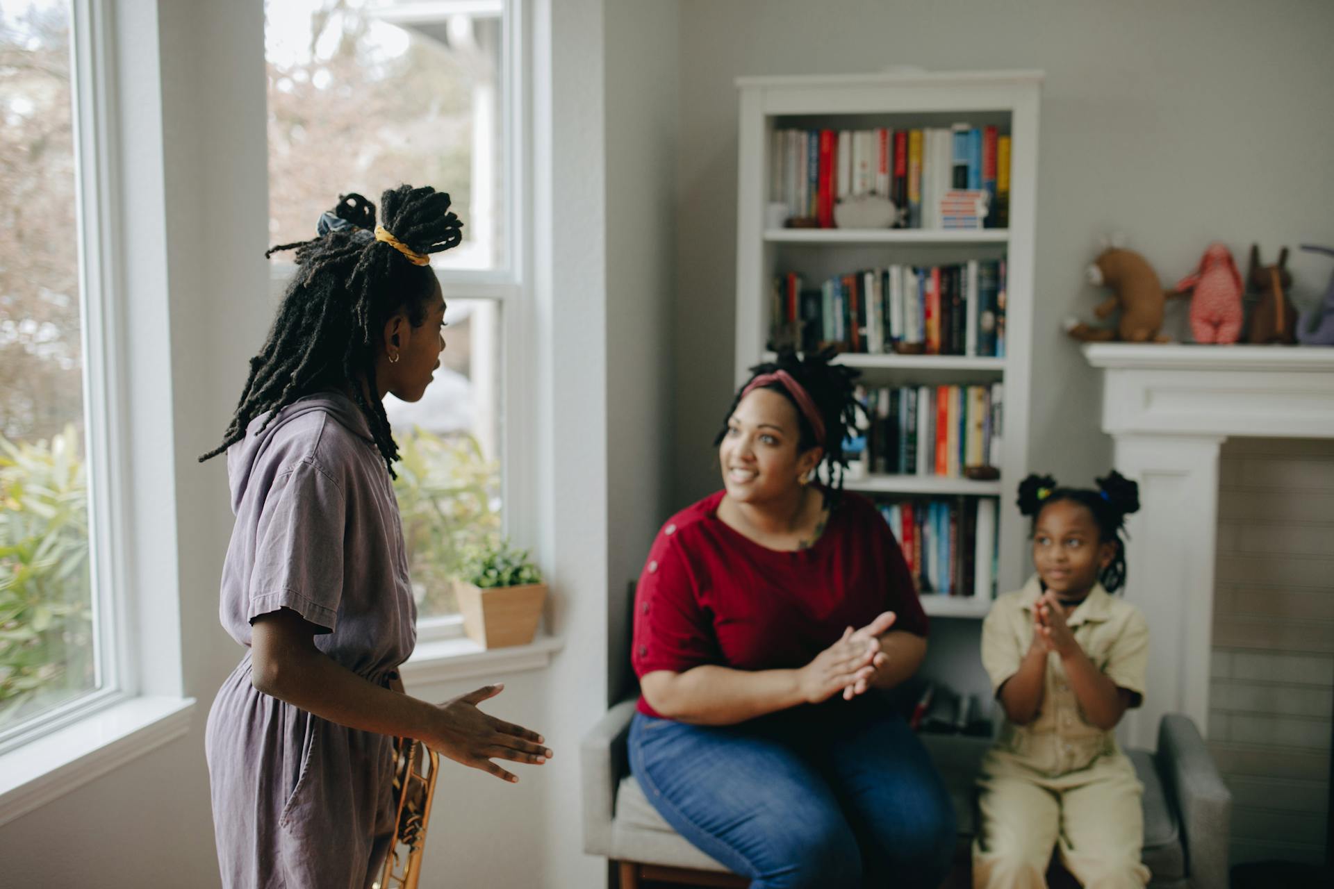 Woman talking to seated woman